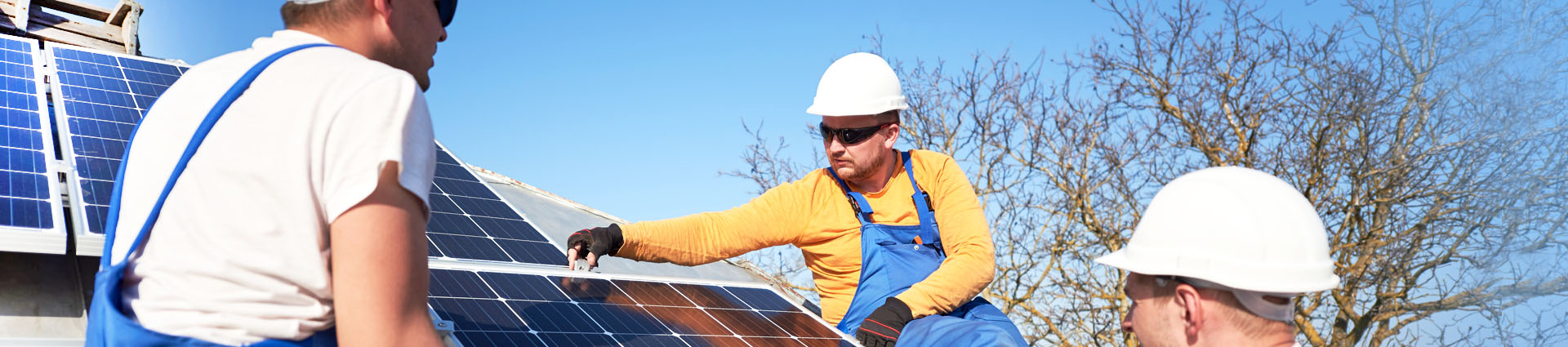 workers on roof with solar panels
