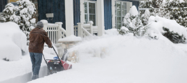 man snow blowing