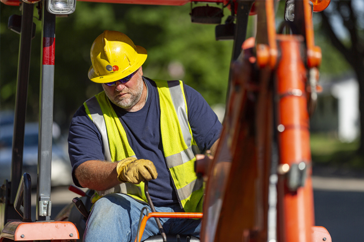 wps employee digging with excavator truck